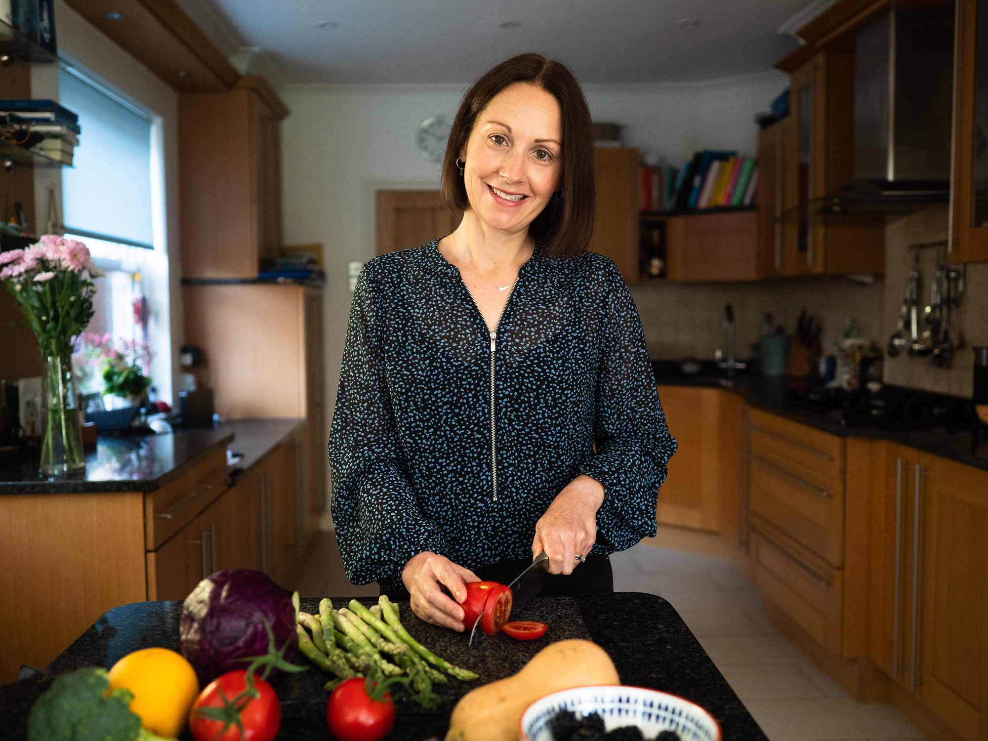 Julia Young preparing fresh vegetables in her kitchen